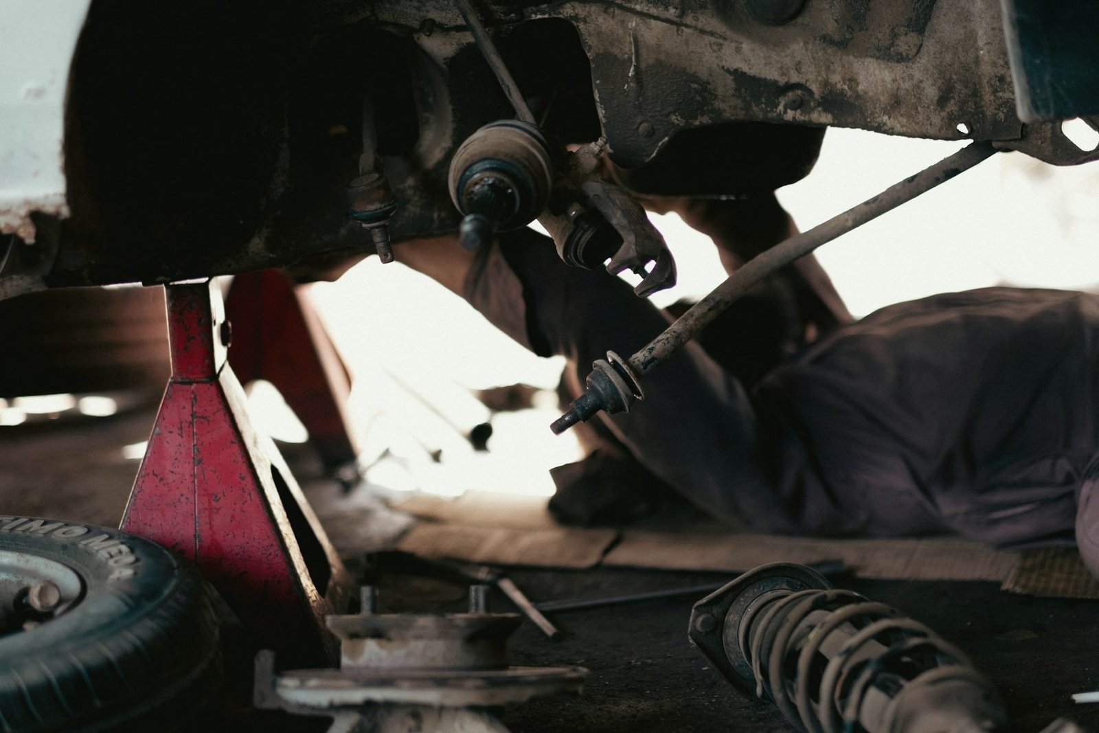 Underside of a car on jack stands with the suspension exposed